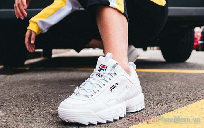 Đôi giày sneaker trắng trên nền gỗ, biểu tượng cho việc tìm kiếm size giày phù hợp cho bàn chân 240mm