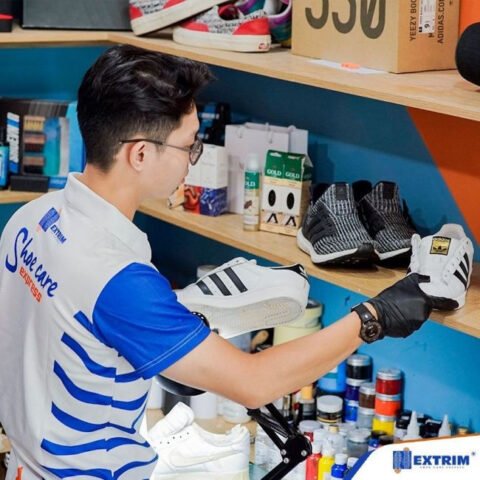 Thợ chuyên nghiệp đang tỉ mỉ sửa chữa phần đế giày sneaker bị hỏng tại TP.HCM